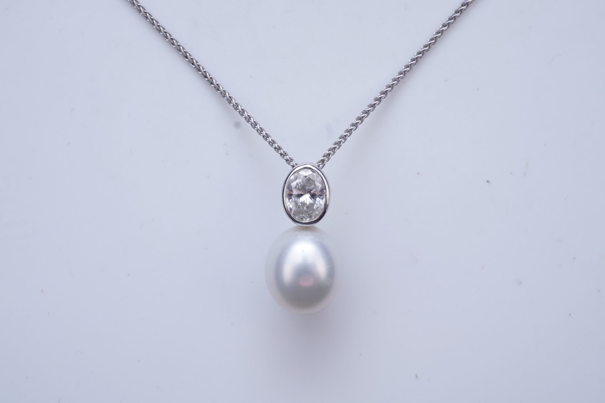 A cultured pearl and diamond pendant